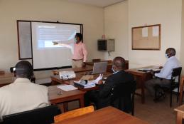 A final year BSc. Mechanical Engineering student presenting his project to a panel of examiners